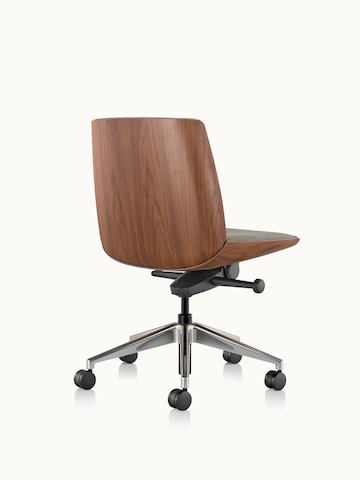 Angle view of a low-back Clamshell office chair with black leather upholstery, a walnut shell, with no arms.
