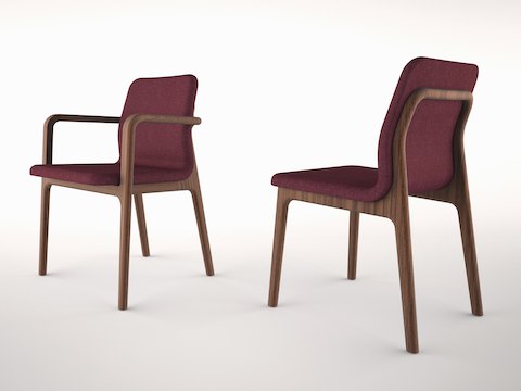 Angled view of two Deft side chairs with burgundy fabric, one with arms and one without.