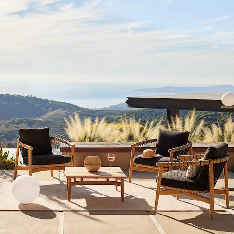 Crosshatch Outdoor Lounge Chairs and Square Coffee Table in an environmental setting overlooking mountain and ocean views.