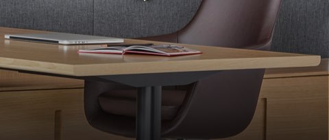 Two Leeway side chairs face a black leather Saiba office chair with a rectangular desk between. Select to go to the All Seating landing page.