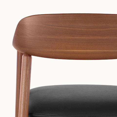 Close-up of the curved wood backrest on a Crosshatch Side Chair, viewed from behind.