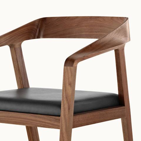 Angled view of the upper half of a Full Twist Guest Chair, showing the sculpted arms and backrest.