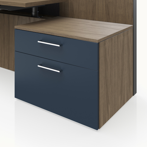 Detail shot of the Geiger One Casegoods storage with a Natural Flat Cut Walnut case and naval blue painted fronts.