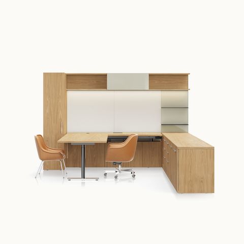 A Geiger One Private Office in Natural Flat Cut Oak with a Bumper Office and Side Chair in camel leather viewed from the front.
