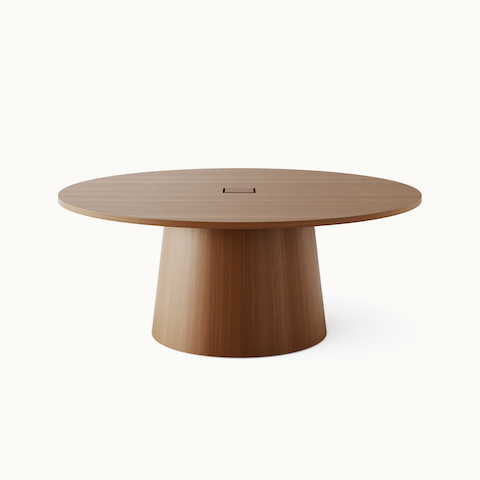 JD Meeting Table by DatesWeiser with round top and round tapered base in natural quarter cut walnut shown at an angle on a white sweep. JD Meeting Table by DatesWeiser with round top and round tapered base in natural quarter cut walnut shown at an angle on a white sweep.