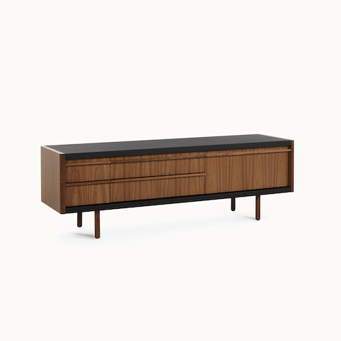 New Canaan Media Unit designed by BassamFellows for Geiger in Walnut with Black Leather shown angled on a white sweep. New Canaan Media Unit designed by BassamFellows for Geiger in Walnut with Black Leather shown angled on a white sweep.
