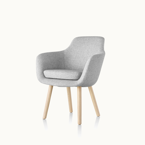 Angled view of a Saiba Side Chair with light gray upholstery and wood legs in a light finish. Select to go to the Saiba Side Chair product page.